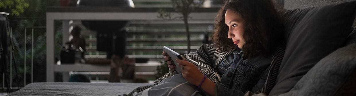 Kvinna sitter och tittar in i en ipad